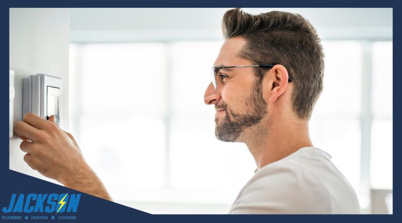 Man setting thermostat